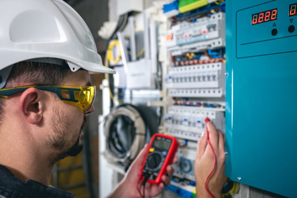 technician testing RCDs or safety switches inside distribution board